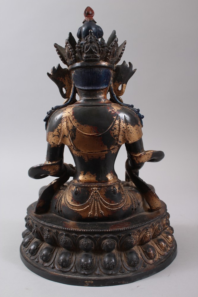 A CHINESE GILT BRONZE FIGURE OF A BUDDHA, seated upon a lotus formed base in a meditating position, - Image 4 of 7