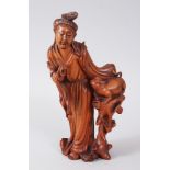 A 19TH CENTURY CHINESE CARVED WOODEN FIGURE OF GUANYIN, guanyin is shown holding a pouch in her