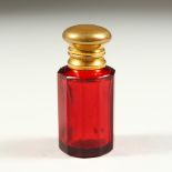 A SMALL VICTORIAN RUBY GLASS SCENT BOTTLE AND STOPPER. 5.5cms high.