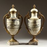 A LARGE PAIR OF VARIEGATED MARBLE AND ORMOLU MOUNTED URNS, with pineapple finials, leaf cast handles