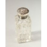 A SMALL VICTORIAN SQUARE CUT GLASS SCENT BOTTLE with screw off silver top. 6.5cms long x 2.5cms