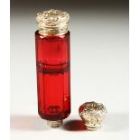 A GOOD VICTORIAN RUBY FACET CUT GLASS SCENT BOTTLE with repousse silver top. 9.5cms long.