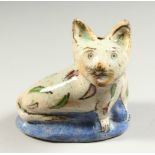 A SMALL PERSIAN POTTERY MODEL OF A CAT. 130cms long.