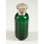 A VICTORIAN GREEN GLASS FACET CUT SCENT BOTTLE with repousse silver top and plain glass stopper. 8.