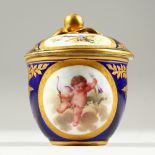 A 19TH CENTURY SEVRES BOWL AND COVER, rich blue ground decorated with framed panels of cupid,
