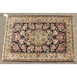 A FINE PERSIAN QUM SILK RUG, the centre with a pattern of flowers on a blue ground, within a
