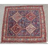A PERSIAN QASHQAI TRIBAL RUG with four large diamond shaped motifs. 6ft x 6ft.