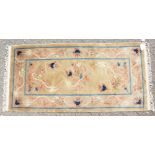 A CHINESE WOOL RUG with Dragon design in blue and green. 4ft 7ins x 2ft 3ins.