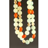 A LONG JADE TWO COLOUR NECKLACE with SIXTEEN PEARLS and gold clasp. 2ft 6ins long.