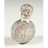 A VICTORIAN CIRCULAR FLASK SHAPED SILVER SCENT BOTTLE AND COVER with allover floral repousse