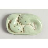 A CHINESE PORCELAIN DOLPHIN WEIGHT. 3cms long.