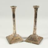 A MATCHED PAIR OF GEORGE III CLUSTER COLUMN CANDLESTICKS on square loaded bases. London 1773 & 1776.