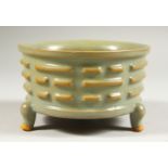 A SMALL CHINESE CELADON CIRCULAR BOWL with ribbed sides on three legs. 4.5ins diameter.