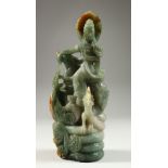 A GOOD CHINESE CARVED JADE GOD WITH A DOG. 9ins high.