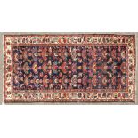 A PERSIAN BAKHTIARI CARPET with numerous designs on a blue ground. 9ft 10in x 5ft 0