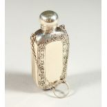 A STERLING SILVER ENGRAVED SCENT BOTTLE on a chain. 6cms long.