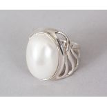 A SILVER AND PEARL RING.