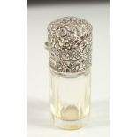 A VICTORIAN PLAIN GLASS SCENT BOTTLE, the repousse top with flowers and scrolls, complete with plain