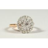 A SUPERB 18CT GOLD AND DIAMOND SET CIRCULAR CLUSTER RING, boxed.