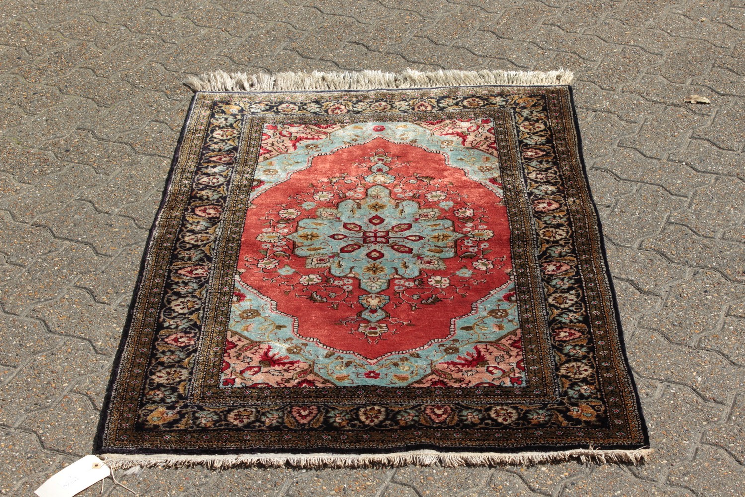A FINE PERSIAN SILK RUG with central motif on a red background and floral border. 4ft 2ins x 2ft - Image 2 of 9