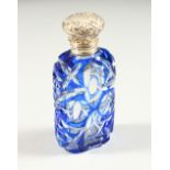 A VICTORIAN BLUE TINTED GLASS SCENT BOTTLE with repousse silver top and plain glass stopper. 9.