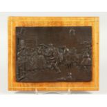 A CONTINENTAL RELIEF CAST BRONZE PLAQUE, depicting an interior scene with figures. 21cms wide x