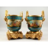 A APIR OF LOUIS XVITH SEVRES STYLE GILT METAL MOUNTED TWO HANDLED JARDINIERES painted with a