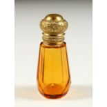 A SMALL VICTORIAN AMBER GLASS SCENT BOTTLE AND STOPPER. 6cms high.