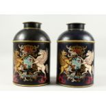 A PAIR OF TOLEWARE SPICE TINS AND COVERS, painted with a crest: DIEU ET MON DROIT. 1ft 2ins high.