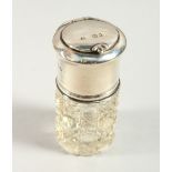 A CUT GLASS SCENT BOTTLE with stopper,the silver mount with lift up top , with a mirror. 6.5cms high