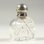 A CUT GLASS PERFUME BOTTLE WITH PLAIN SILVER SCREW OFF TOP. 5.5cms long.
