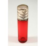 A VICTORIAN PLAIN RUBY GLASS SCENT BOTTLE AND STOPPER with engraved silver cap. 7cms long x 1.5cms