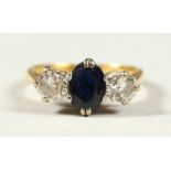 AN 18CT GOLD, PLATINUM, DIAMOND AND SAPPHIRE THREE STONE RING.