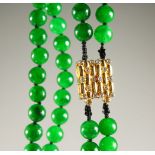 A VERY GOOD APPLE GREEN JADE NECKLACE, with 18ct gold and diamond clasp.
