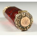 A VICTORIAN RUBY FACET CUT DOUBLE ENDED SCENT BOTTLE with screw off cap, the other end a