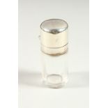 A SMALL VICTORIAN CIRCULAR PLAIN SCENT BOTTLE with silver top and plain glass stopper. London