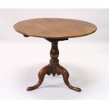 A GEORGE III MAHOGANY CIRCULAR TILT TOP TRIPOD TABLE, with "bird cage" action, baluster column