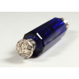 A VICTORIAN FACET CUT BRISTOL BLUE DOUBLE ENDED SCENT BOTTLE AND STOPPERS with repousse silver ends.