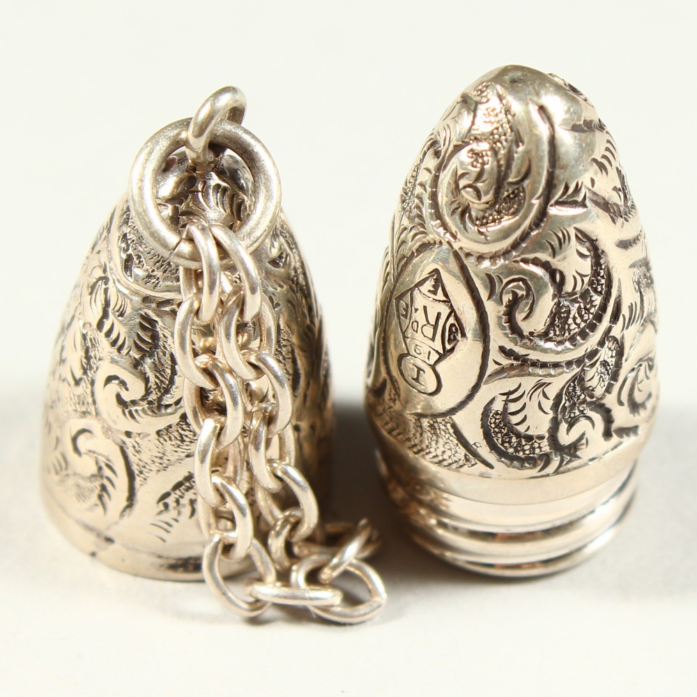 A SMALL VICTORIAN BULLET SHAPED SILVER SCENT BOTTLE with engraved decoration on a chain. 4.5cms - Image 5 of 6