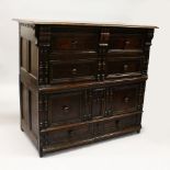 A 17TH CENTURY OAK FOUR DRAWER CHEST with plain three plank top, turned wood handles, on short feet.