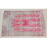 AN ANTIQUE PERSIAN KASHAN SILK RUG with floral design on a red ground. 6ft 2ins x 4ft 1in.