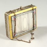 A SMALL FRENCH SILVER AND ENAMEL COMPACT with fitted mirror. 2.75ins long.