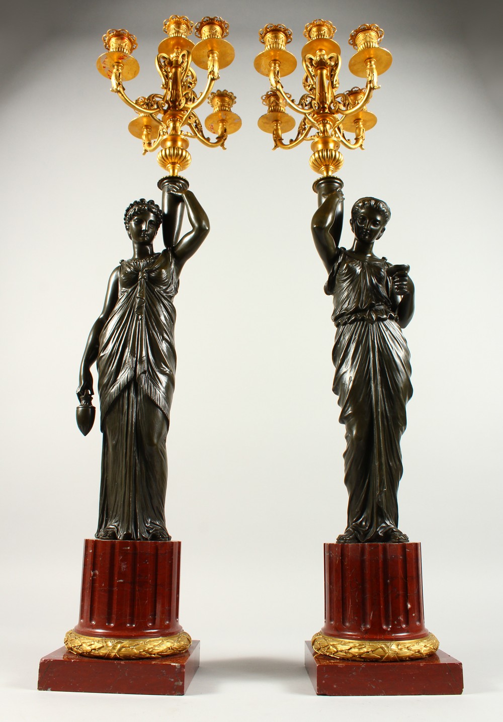 A VERY GOOD PAIR OF BRONZE, ORMOLU AND MARBLE CANDELABRA, modelled as a pair of classical femal