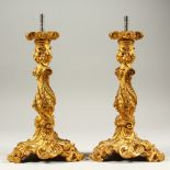 A PAIR OF ORMOLU LAMP BASES in the Rococo style. 26cms high.