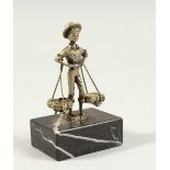 A SMALL CONTINENTAL SILVER FIGURE OF A MAN carrying two baskets, on a marble base. 3.5ins high.