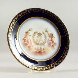 A SEVRES CIRCULAR PLATE, rich blue and gilt border and a Royal Crest. 9.25ins diameter.