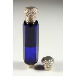 A VICTORIAN BRISTOL BLUE GLASS FACET CUT DOUBLE ENDED SCENT BOTTLE with repousse silver caps.