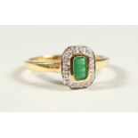 A 9CT GOLD EMERALD CUT EMERALD AND DIAMOND RING, boxed.