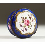 A SMALL 19TH CENTURY CONTINENTAL CIRCULAR ENAMEL PILL BOX, the hinged cover painted with flowers.