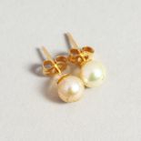 A SMALL PAIR OF PEARL STUDS.